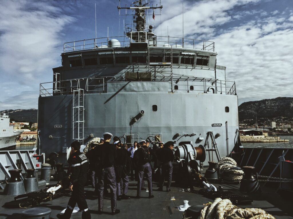 Photo of a ship with the crew in front of it, which signifies the need for strong first mate resume example reflecting a first mate’s leadership