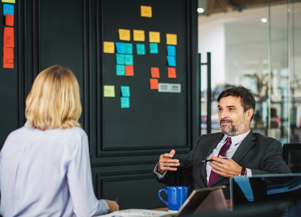 Good psychometrician resume examples are those that focus on the related jobs and key credentials, as shown here in the photo of an employee and psychometrician talking 