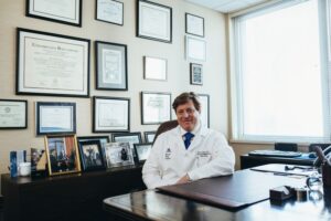 Male hospital administrator seats inside his office that denotes his success as seen in hospital administrator resume examples