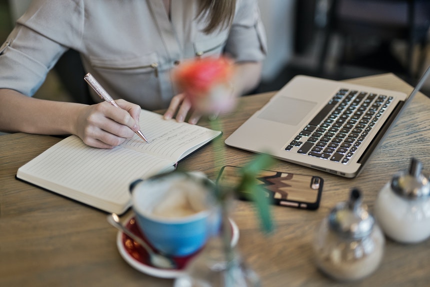 Woman taking notes on how to use a resume builder