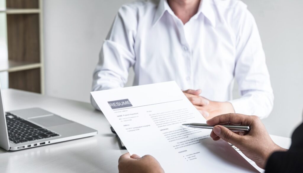 HR manager reviewing edited resume template in front of the applicant