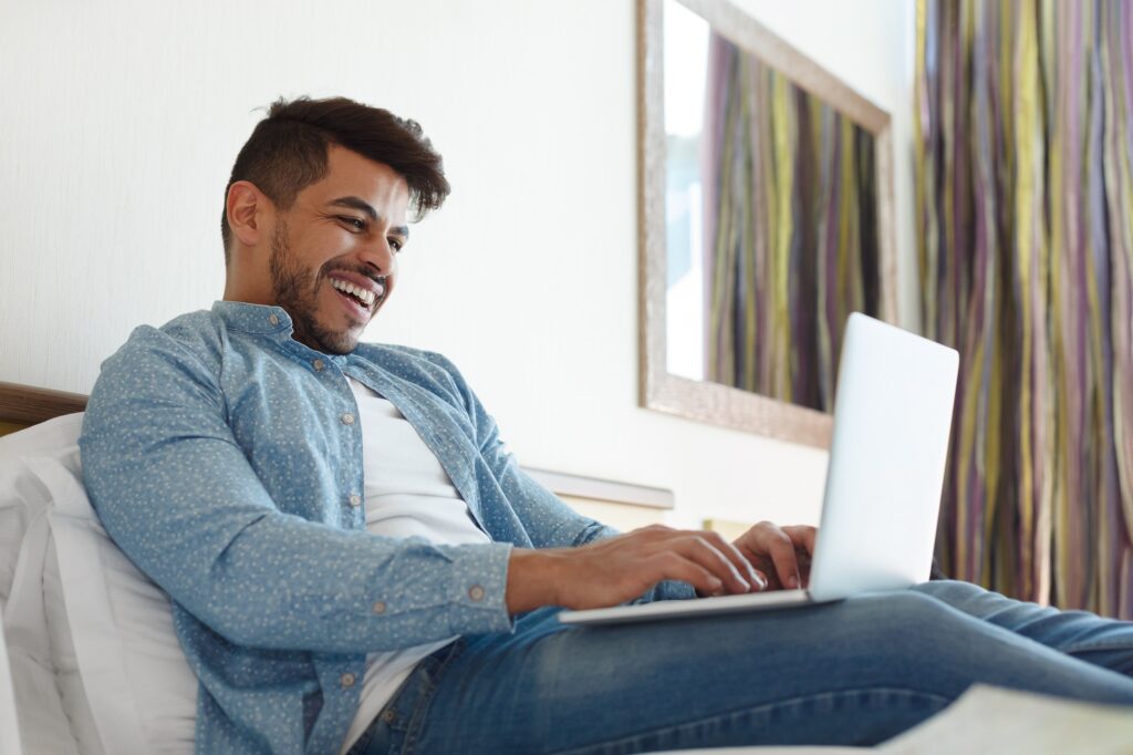 a happy job seeker using a free resume builder for his CV