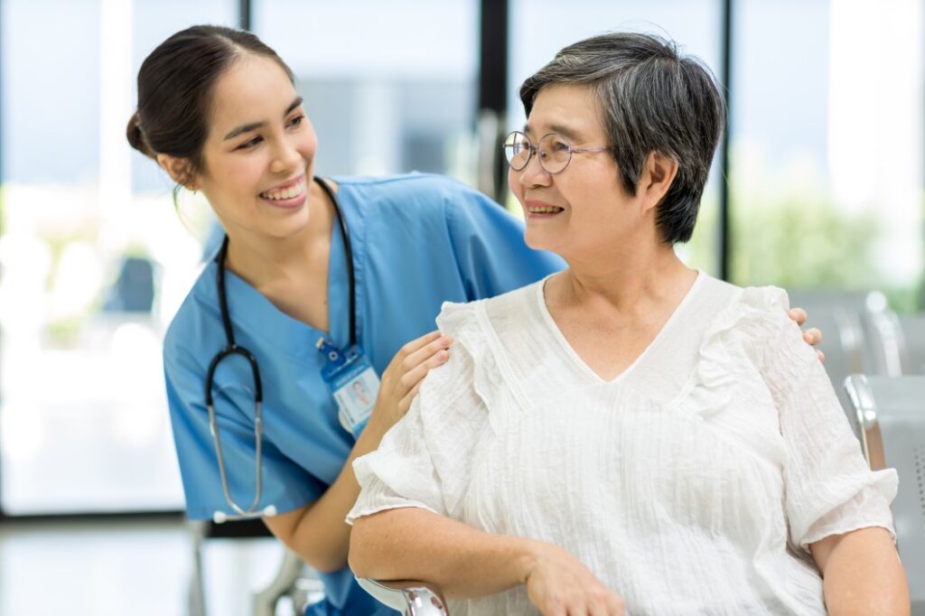 A charge nurse is assisting patient with smile