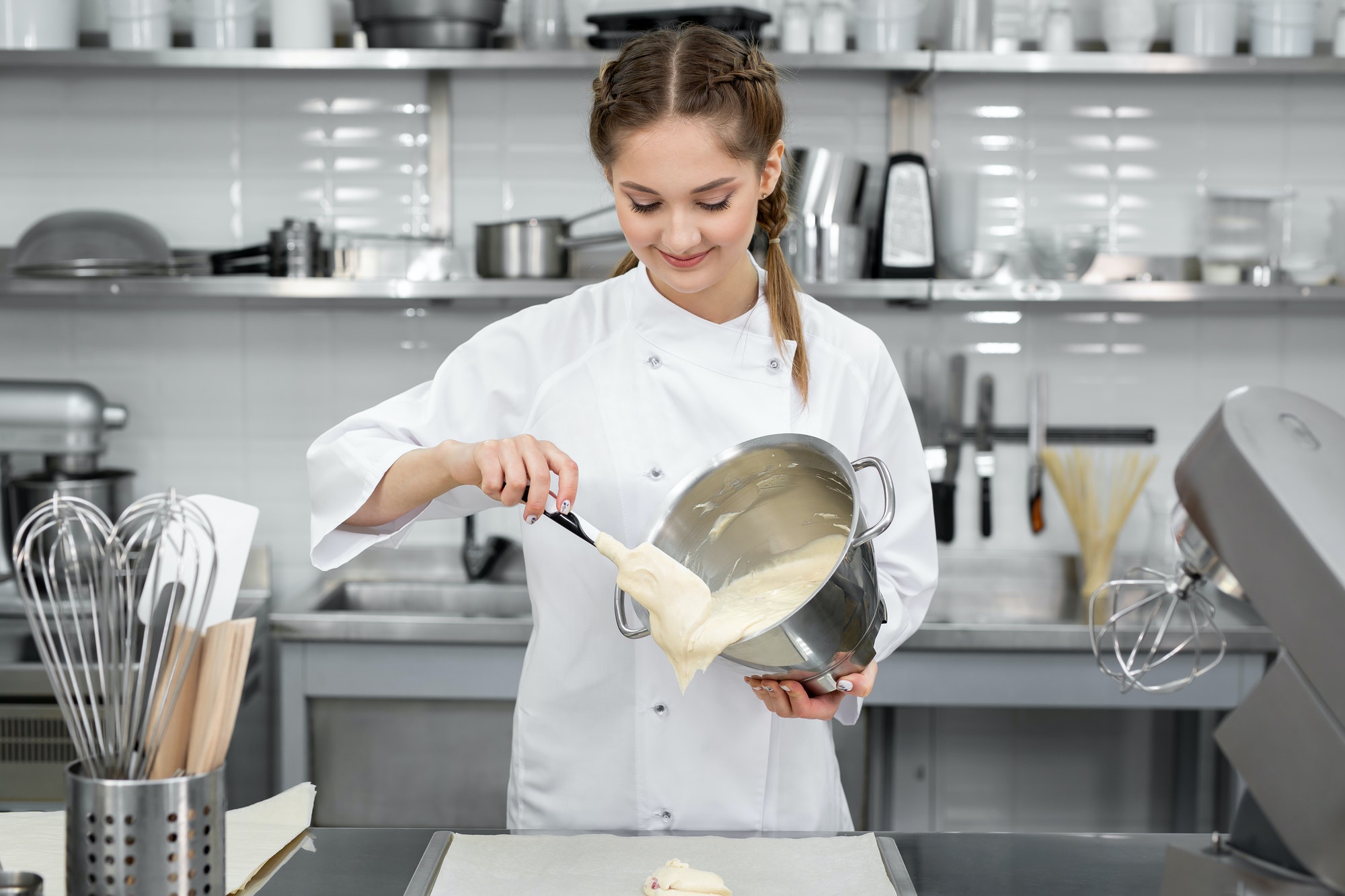 Pastry chef pours the biscuit on the baking parchment