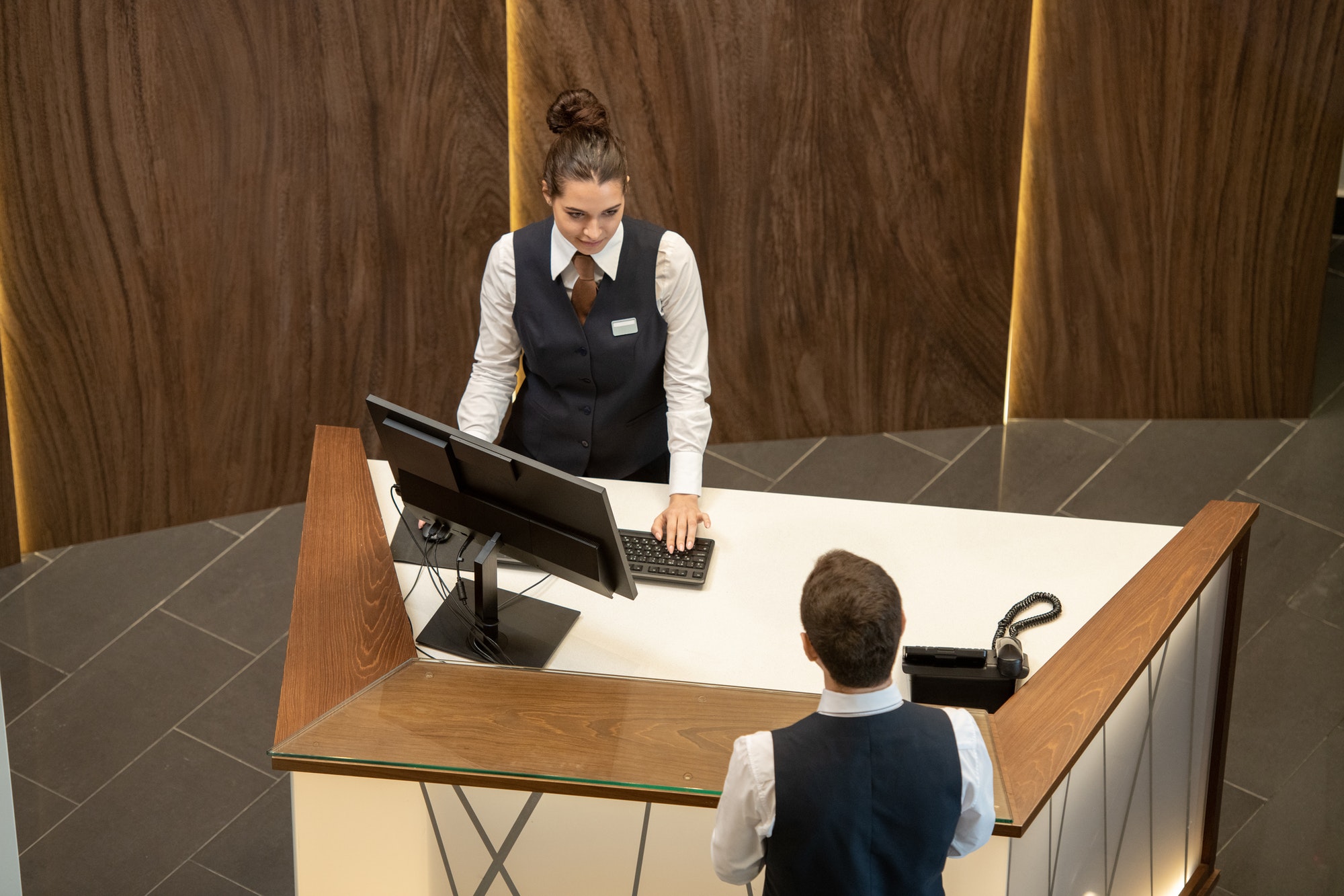 Young hotel managers communicating by counter